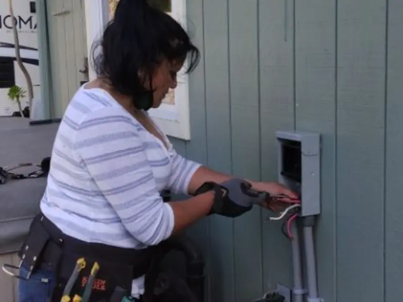 Licensed electrician wiring an exterior subpanel in Sabattus
